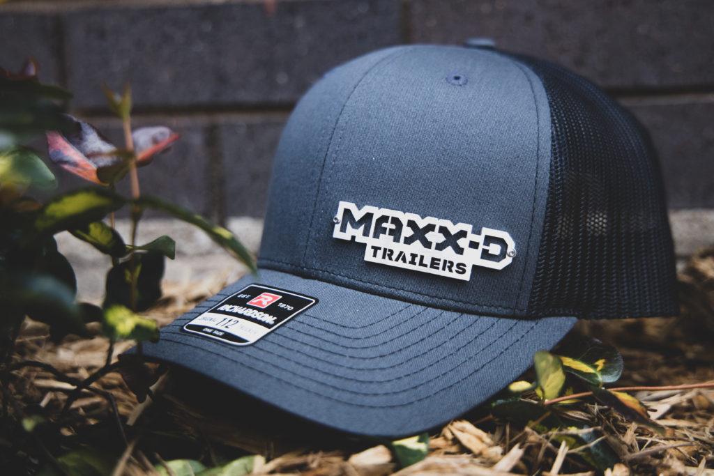 MAXX-D photograph outdoors in overcast lighting showing detail of the laser cut stainless steel logo badgecap