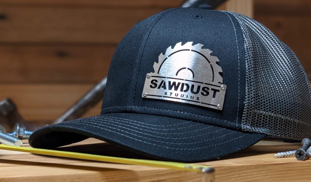 closeup photo of sawdust studios custom metal badgecaps