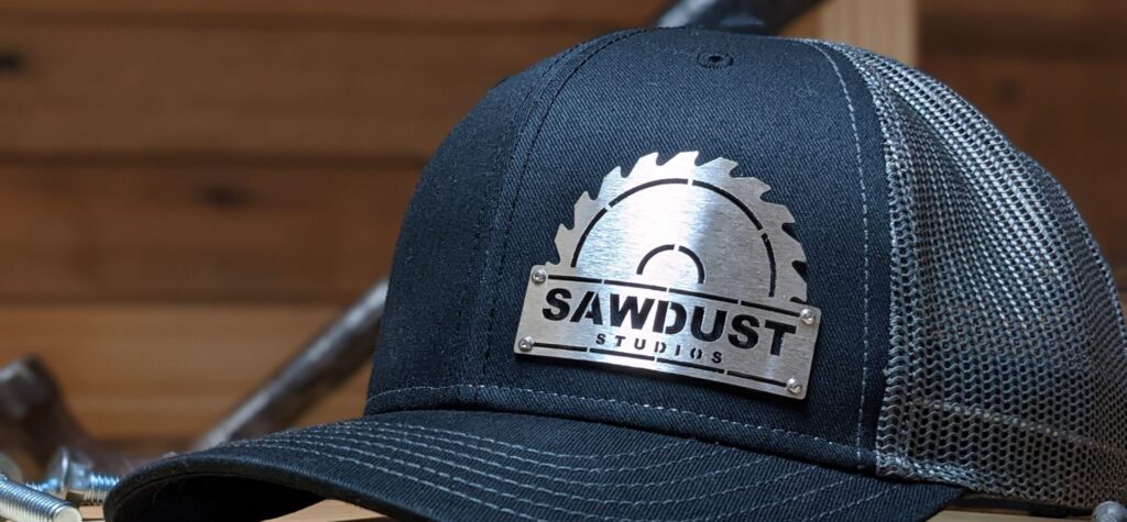 closeup photo of sawdust studios custom metal badgecaps