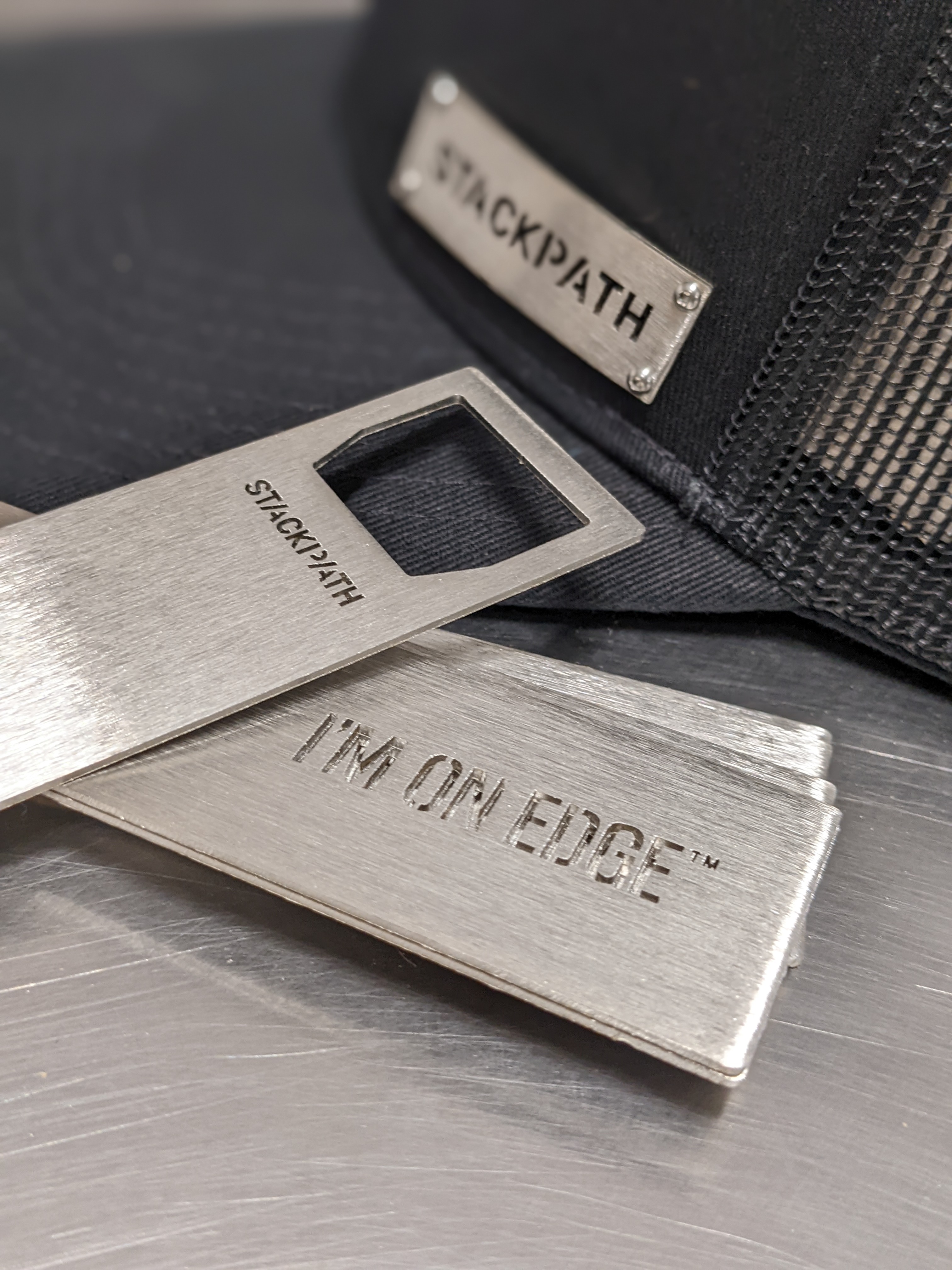 Photo of StackPath custom stainless steel bottle openers and metal badgecaps with logo laser cut